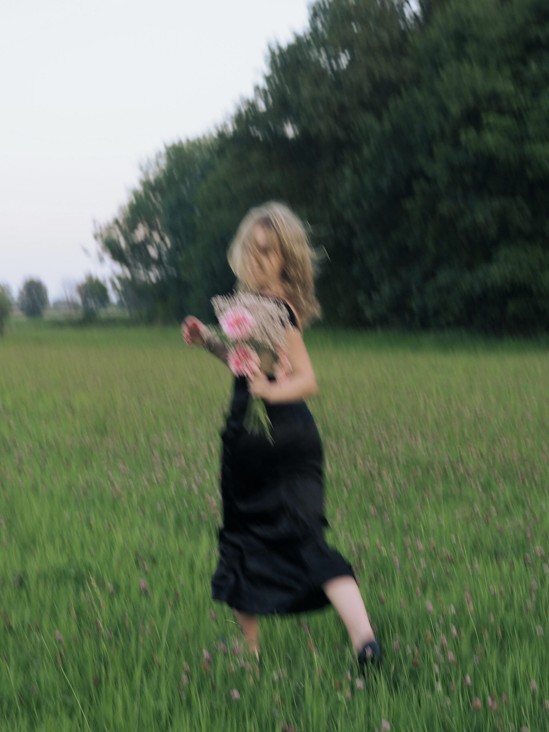 Flower girl A girl running in a field holding flowers