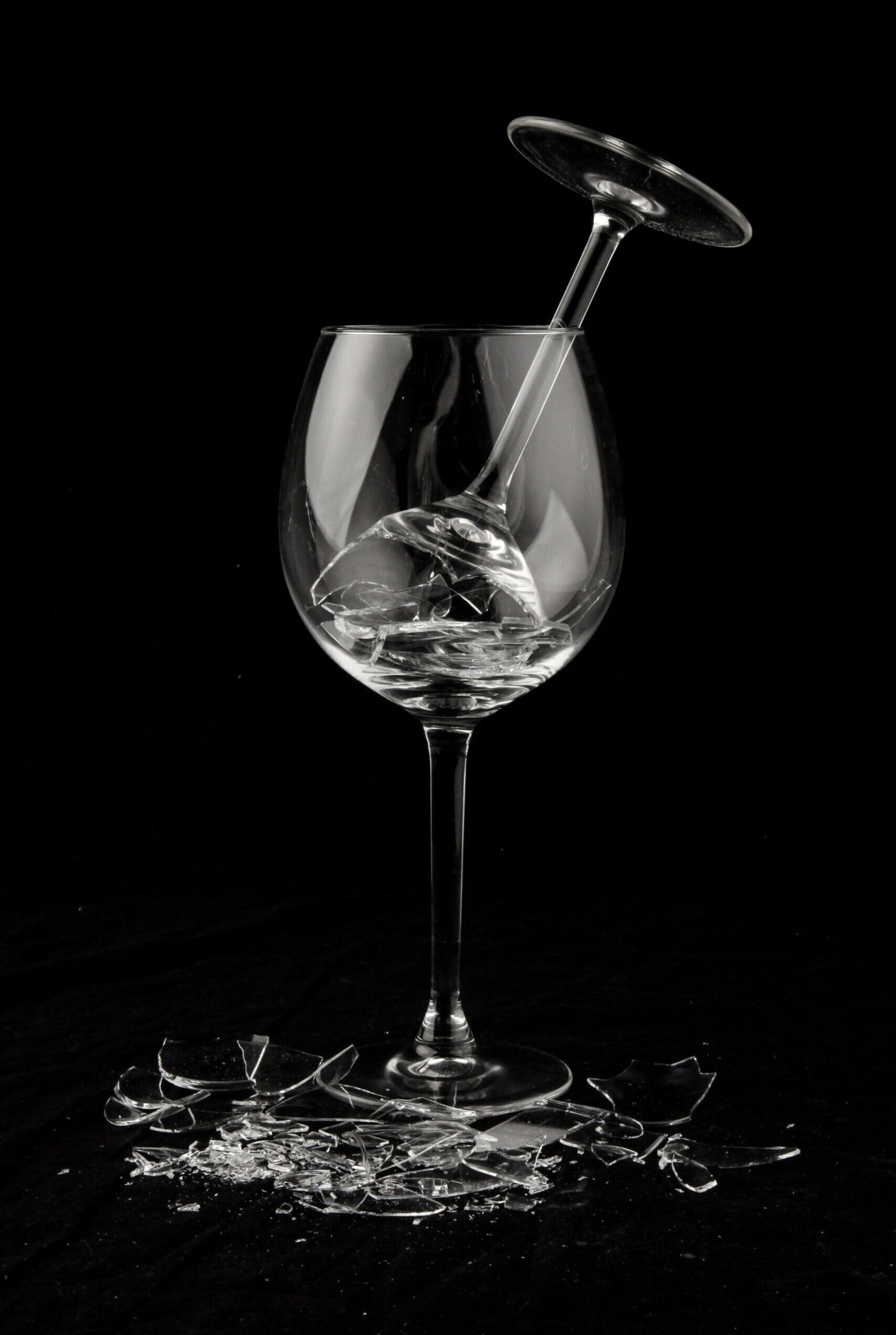 A still life of a broken wine glass